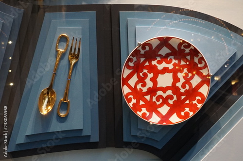 white-red plate, golden spoon and fork