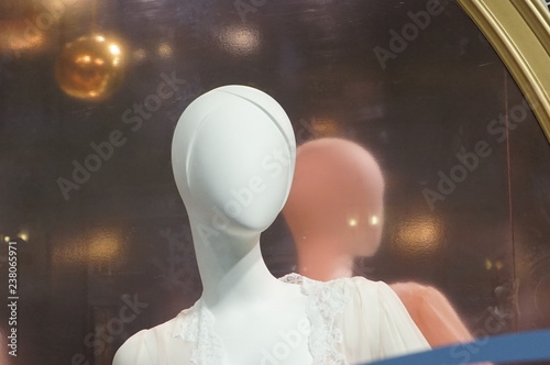 white mannequin with a reflection on background