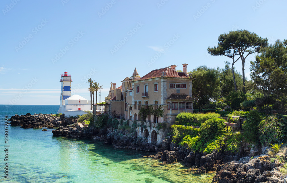 view to lighthouse in lagoon with old villa in Portugal