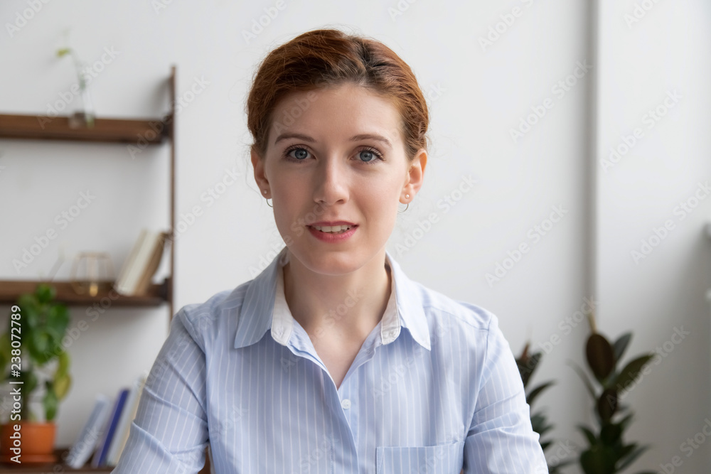 Head shot businesswoman sitting in office room or home looking at web camera using computer. Executive manager or representative of company make video call conference communicating online with client Head shot businesswoman sitting in office room or home looking at web camera using computer. Executive manager or representative of company make video call conference communicating online with client