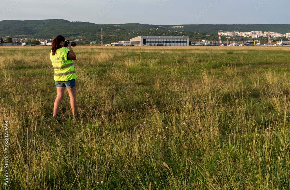 A photographer takes photos of take-off and landing planes.