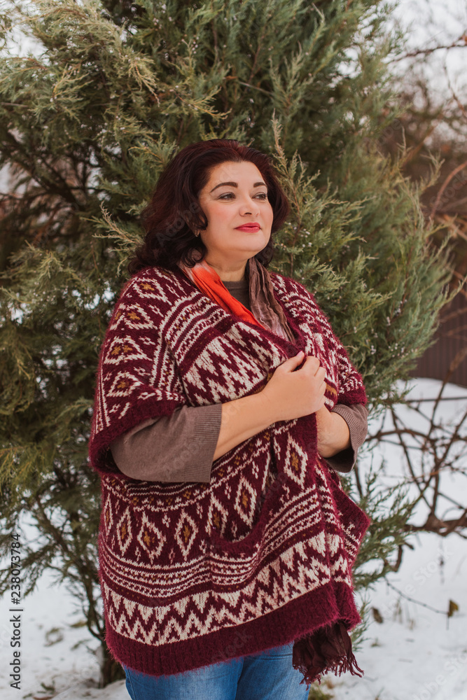 Christmas, winter holidays concept. Beautiful plus size woman walk at park. Love and peace for women, psychology and lifestyle of mature ladies Christmas, winter holidays concept. Beautiful plus size woman walk at park. Love and peace for women, psychology and lifestyle of mature ladies
