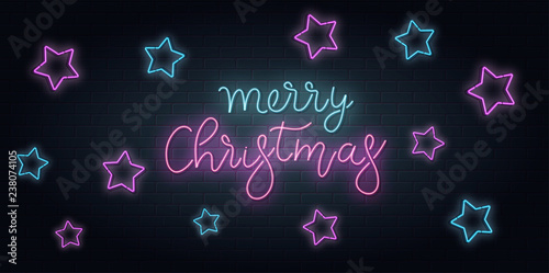 Christmas greeting card, vector background. Christmas lettering in Neon style on brick background. Blue and Purple neon colors, neon stars.. Hand drawn lettering. Vector illustration