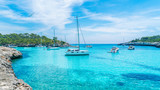 Landscape with boats and turquoise sea water on Cala Mondrago, Majorca island, Spain
