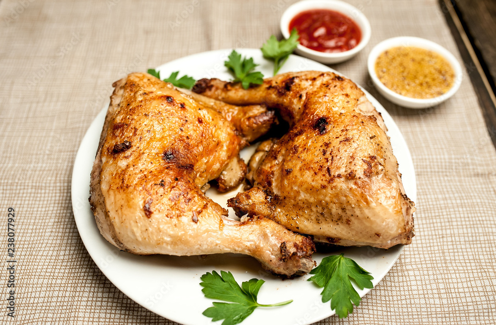 Chicken legs in a plate with mustard and ketchup on a wooden background. Chicken legs in a plate with mustard and ketchup on a wooden background.