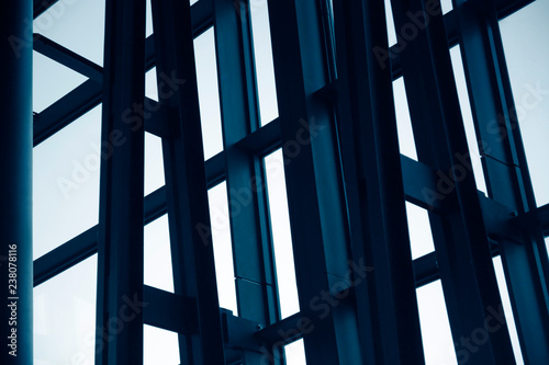 Steel and glass structure with metal framework of an office building exterior fragment. Abstract modern architecture background.