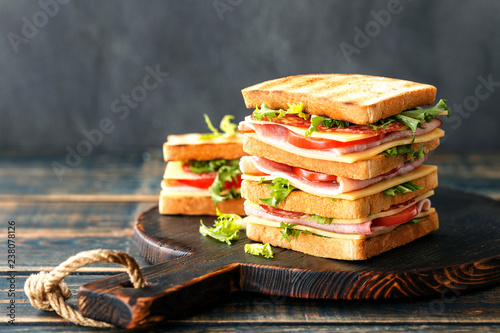 sandwiches with grilled toast ham salami cheese tomatoes and lettuce photo