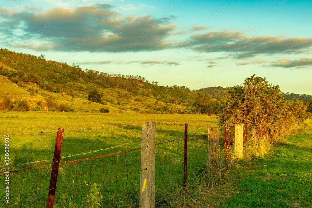 Sunset on rural fence and hills west of Picton town Australia