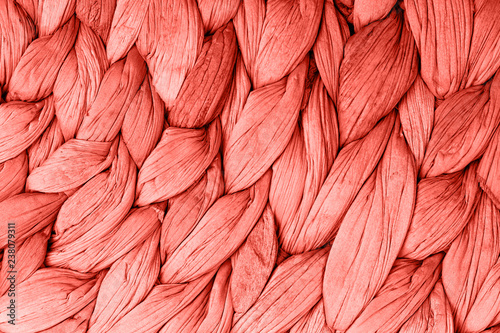 Abstract woven mat texture background living coral color. Trendy concept color of the year. photo