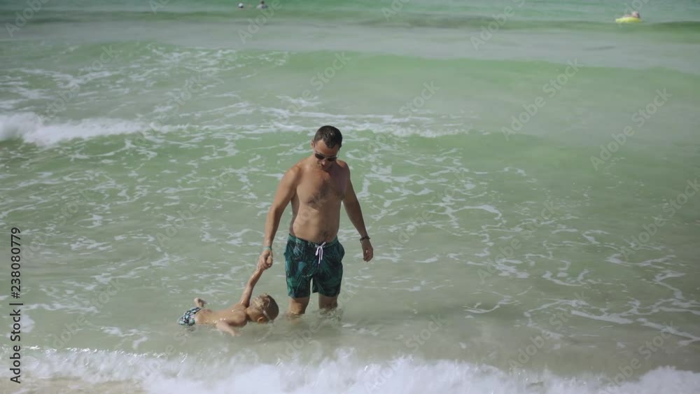 Young father and his little son have fun playing at the beach. 4k Young father and his little son have fun playing at the beach. 4k