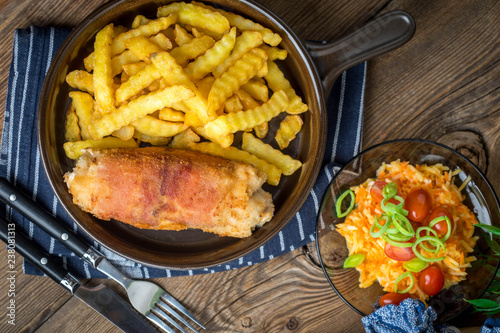 Fried chicken breast stuffed with mushrooms and cheese wrapped in ham served with fries and salad.