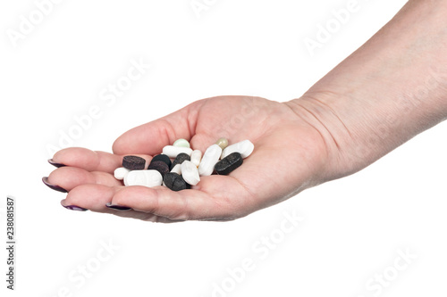 heap of pills in a female hand