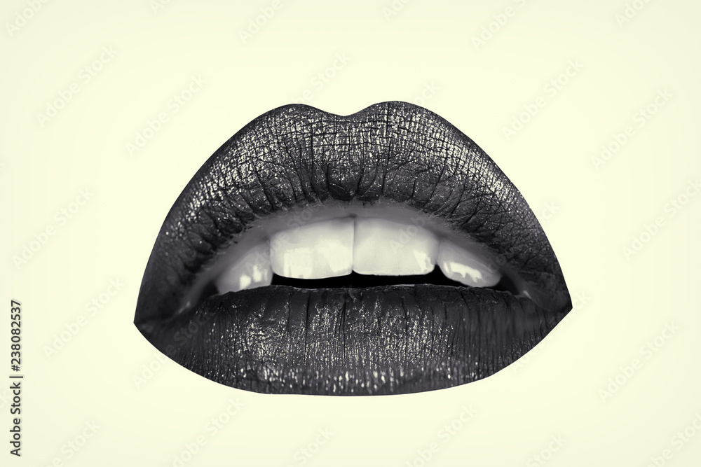 Female lips isolated on white background and colored in dark matte lipstick. Lip trendy make up