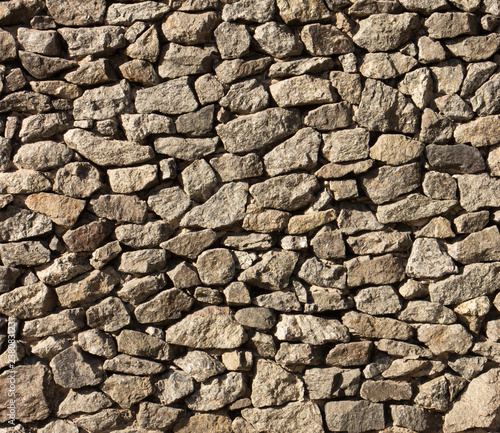 Dry old stone wall texture background close up