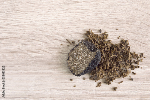 Fotografi black truffle mushroom on a wooden table with space for your text