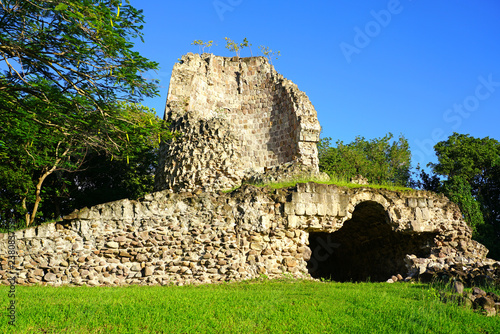 View of the ruins of an old sugar mill at the foot of the Nevis Peak volcano at the Four Seasons Nevis on the island of Nevis. photo