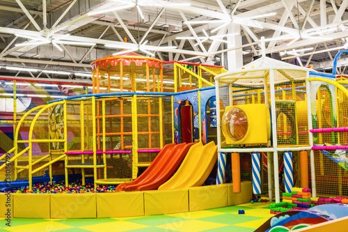 фотографія large children's playroom with a slide and colorful balls in entertainment cente