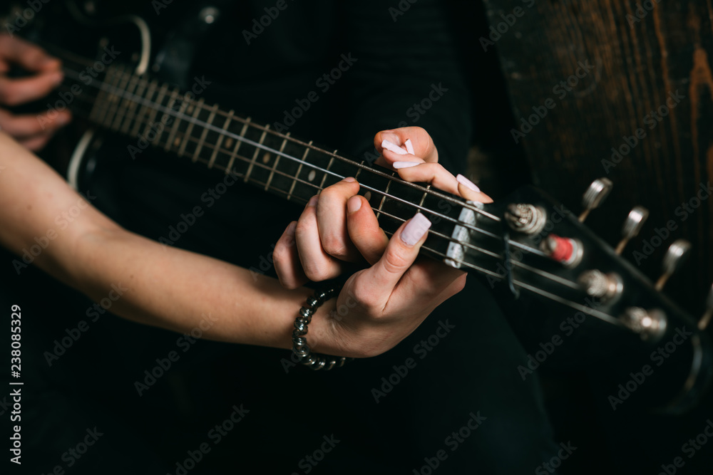 On the music waves. Couple in love play duets. Couple of musicians enjoy playing music. Male and female hands play the electric guitar. Couple of guitar players. Instrumental music live