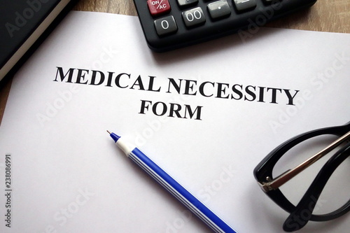 Obraz na plátně Medical necessity form, pen and glasses on desk