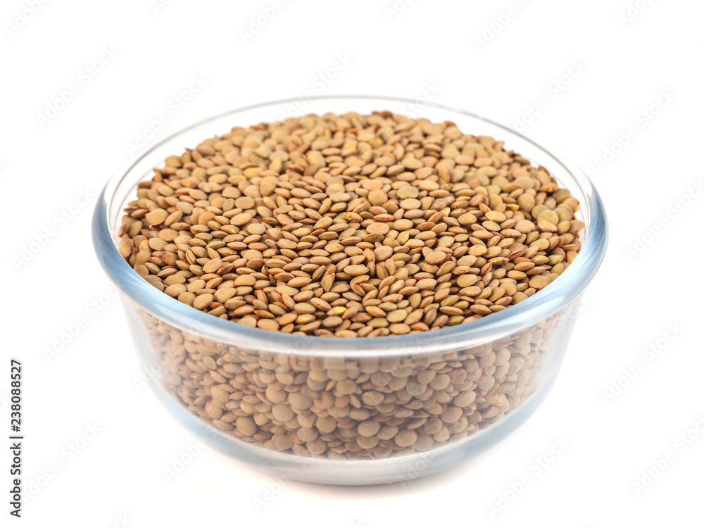 Dry lentil in glass bowl isolated on white background Dry lentil in glass bowl isolated on white background