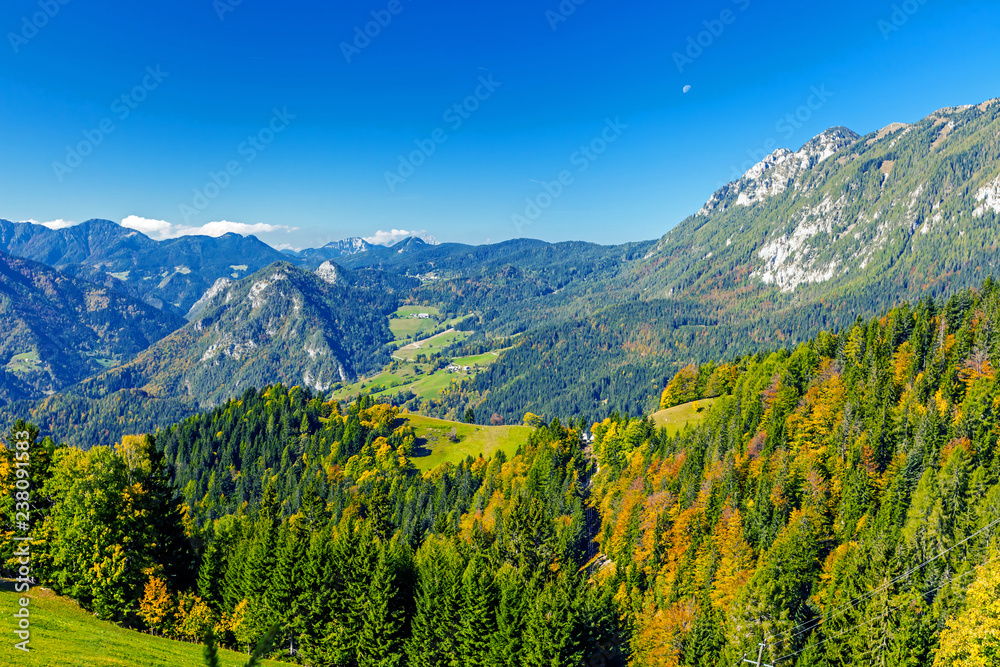 View on the curved meadows in early autumn from the starting point of the mountain lift. Vicinity of Velika Raduha mountain, Slovenia.