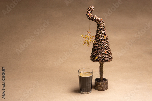 Do-it-yourself coffee tree made from coffee beans with bead ornaments and a glass of coffee
