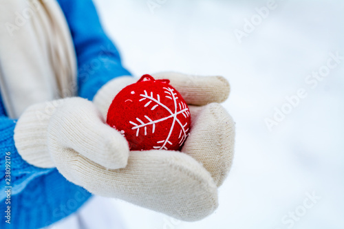 Tableau sur toile girl holds in her hands an decoration for a New Year tree in the shape of a heart