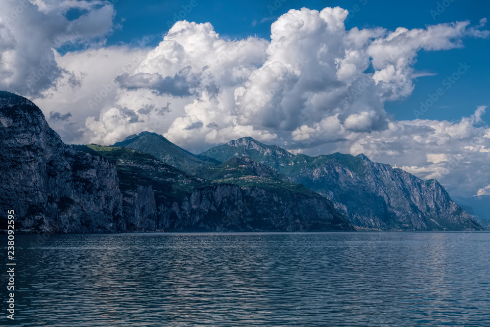View of Lake Garda and mountains on a cloudy day.