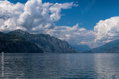 View of Lake Garda and mountains on a cloudy day.
