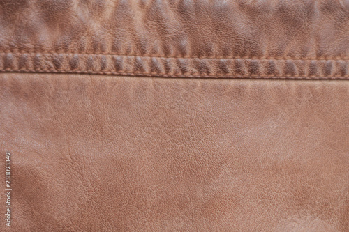Brown background of leather texture stitched stitch. Old, worn