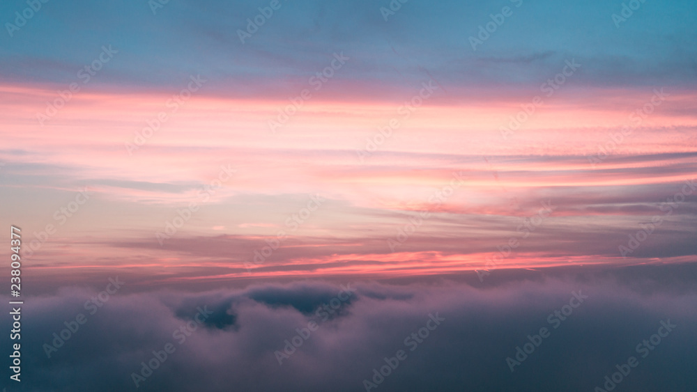 Cloudy sunset against blue sky Cloudy sunset against blue sky