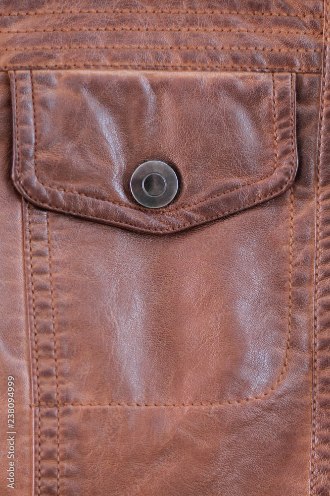 button pocket on old worn leather jacket. background button pocket on old worn leather jacket. background