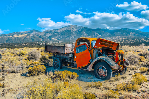 Rusty Old Abandoned Truck in the Desert in front of the Mountains