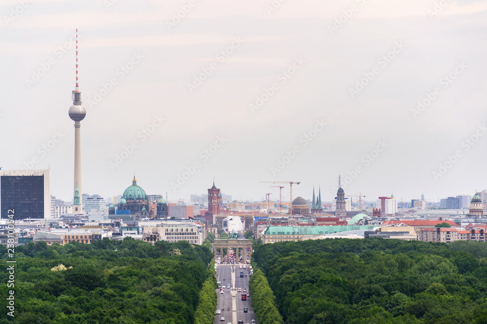 Berlin summer skyline aerial view of  Brandenburger Tor - Brandeburg gate and television tower Fernsehturm with cars passing crossroad under Victory Column in Tiergarten, Berlin, Germany