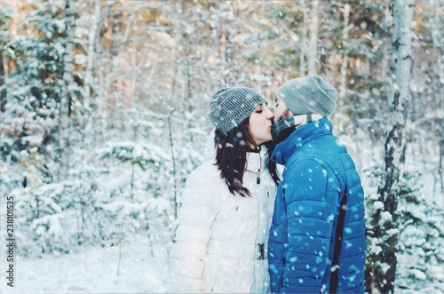 happy couple in love in winter forest
