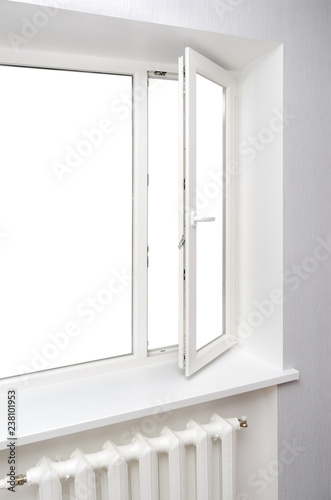 White window in empty room with heating and gray walls.
