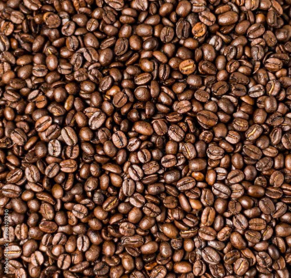 Brown roasted coffee beans, seed on dark background. Espresso dark, aroma, black caffeine drink. Closeup isolated energy mocha, cappuccino ingredient.