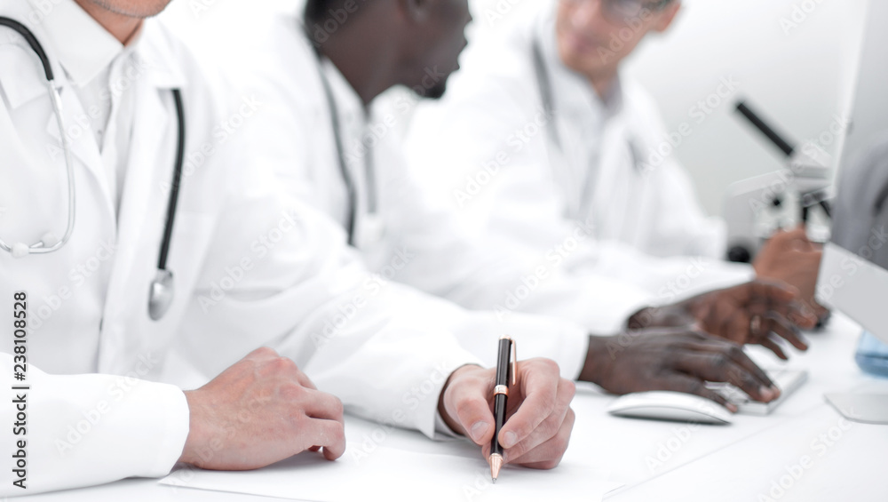 doctor writing down the data in the laboratory journal doctor writing down the data in the laboratory journal