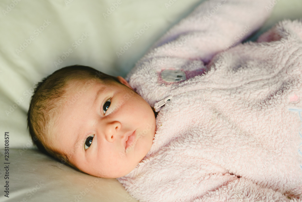 Portrait of relaxed baby girl with pink pajamas. Portrait of relaxed baby girl with pink pajamas.