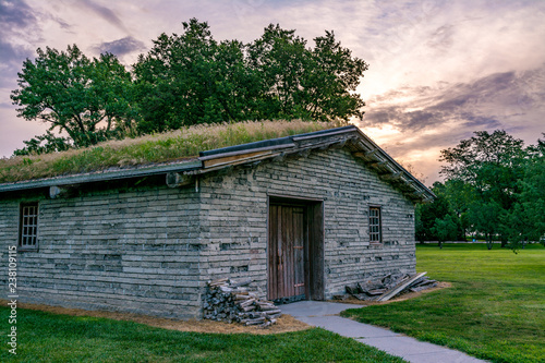 Military quarters made from mud bricks with a sod roof at sunrise photo