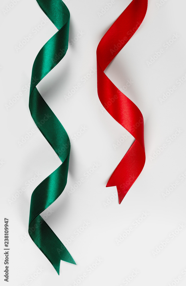 Red and green satin ribbon on white background Red and green satin ribbon on white background
