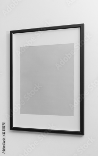 Black wooden frame with white margin space on white wall