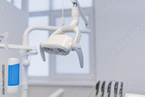 Professional Dentist chair lamp tools in the dental office. Dental Hygiene and Health conceptual