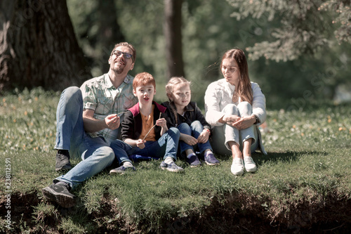 happy family resting in the Park on a summer day.