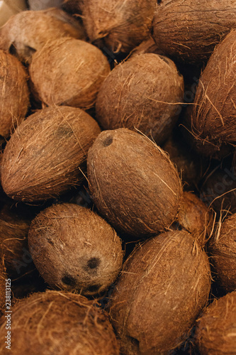 Pile of coconuts, tropical fruits background