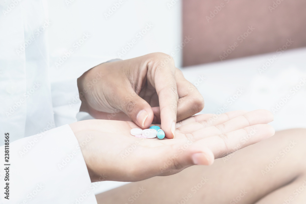 Fototapeta premium Asian women take a medicine on bed.