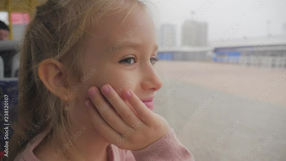 Little girl is looking through window while sitting in train. Little girl is looking through window while sitting in train.