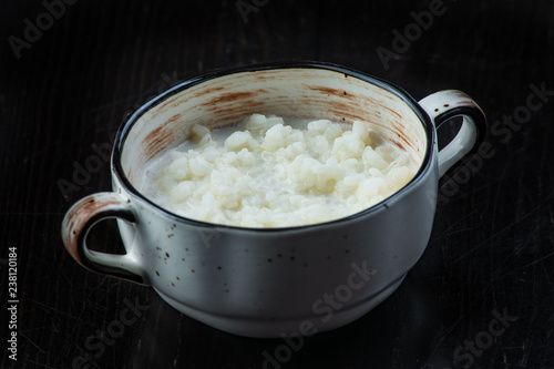 rice pudding in white plate on dark background