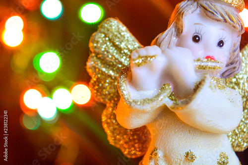 Angel with gold wings on background of bokeh lights. Christmas  New Year picture