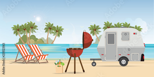 Retro caravan on the beach and picnic with outdoor barbecue.